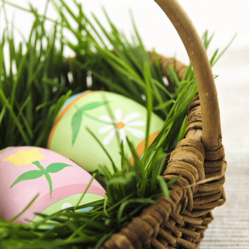 Pastel eggs in a grass-lined Easter basket