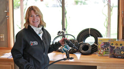 Gardener displaying drip irrigation tubing, fittings, and components