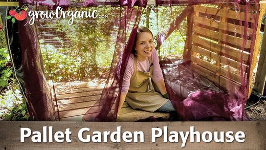 Child sitting inside a wooden pallet garden playhouse