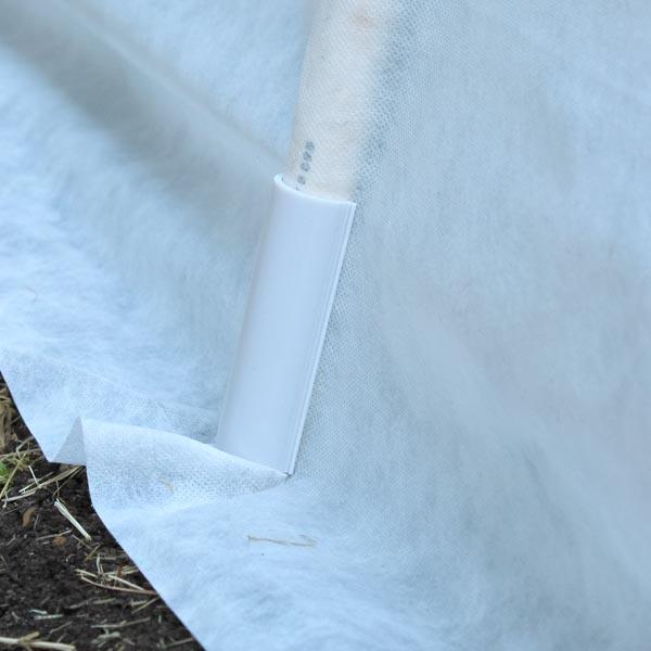 Snap fitting attached to white row-cover fabric