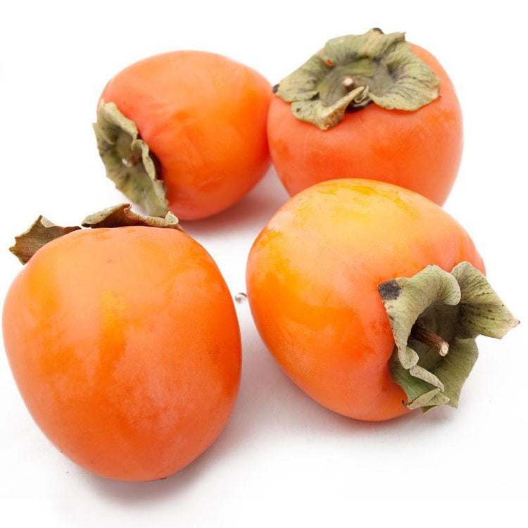 Three ripe orange persimmons