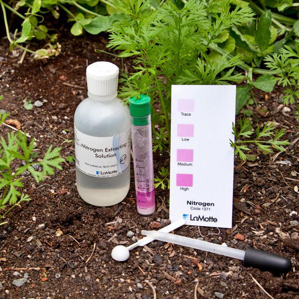 Soil test kit arranged in a garden bed