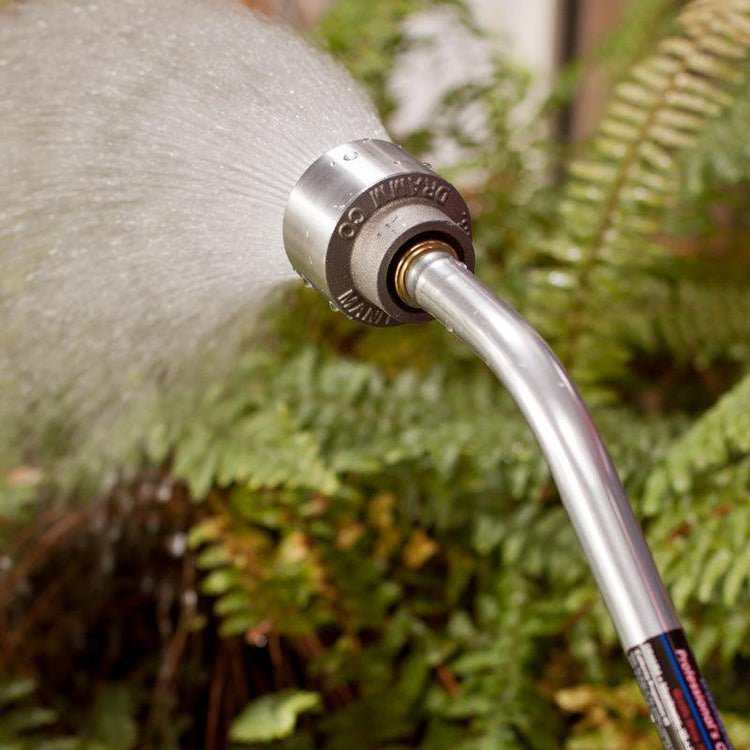Metal hose nozzle spraying a fine mist