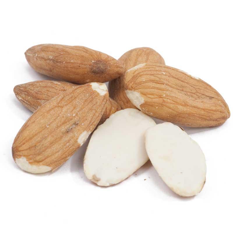 Brown-skinned almonds and blanched almond kernels on white
